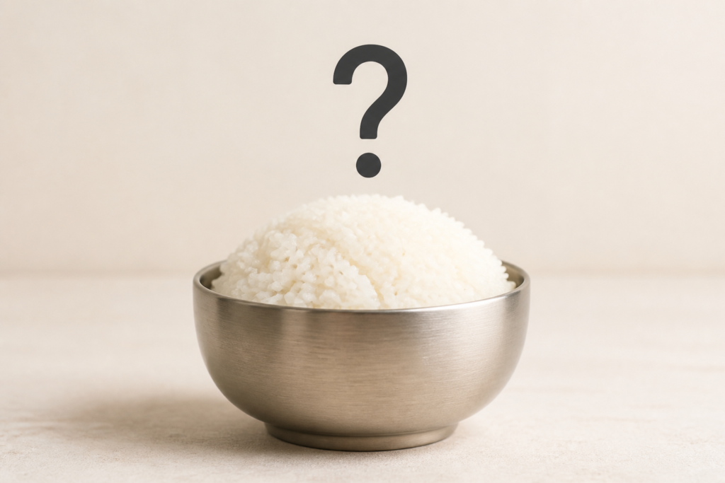 A bowl of steamed white rice with a question mark above it